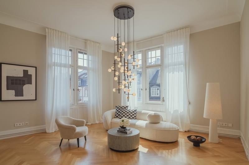 Home staging of an elegant luxury apartment with designer furniture, equipped with an eye-catching lamp and stylish flooring.